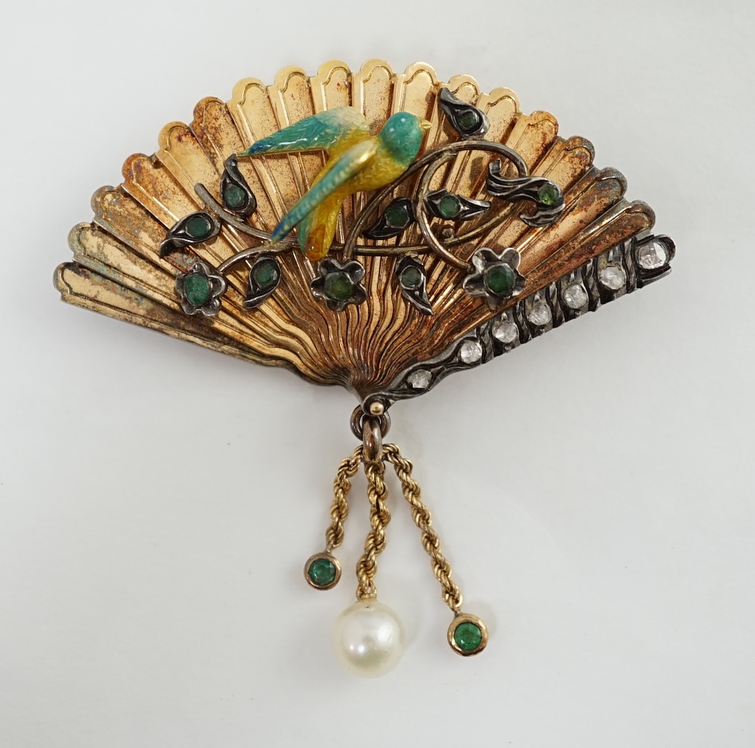 A gold (test as 15ct), emerald, rose cut diamond and enamel set brooch, modelled as a fan with applied parrot on a branch